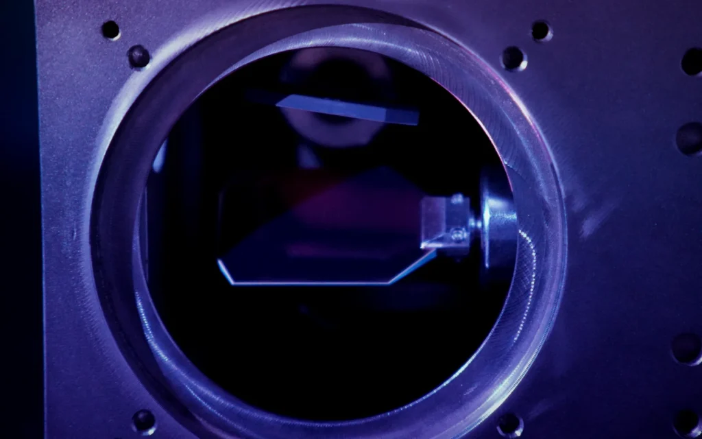 Optical mirror assembly photographed under blue laboratory illumination